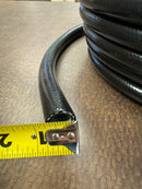 Close-up of new 1/2 inch black silicone hose, with a measuring tape indicating its total diameter.