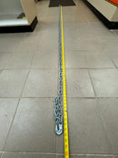 New 1/4 inch galvanized Grade 30 tow chain stretched out, showing its approximate 10-foot length with a tape measure.