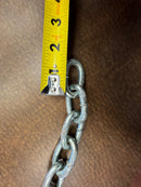 Close-up of a single link from a new 1/4 inch Grade 30 tow chain, with a ruler measuring its length.