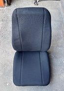 Top-front view of a brand new black cloth bucket seat, ideal for Humvees, Broncos, Blazers and farm equipment.