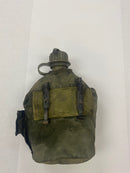 Back view of the like new US military canteen with its green canvas cover, showing belt attachment points.